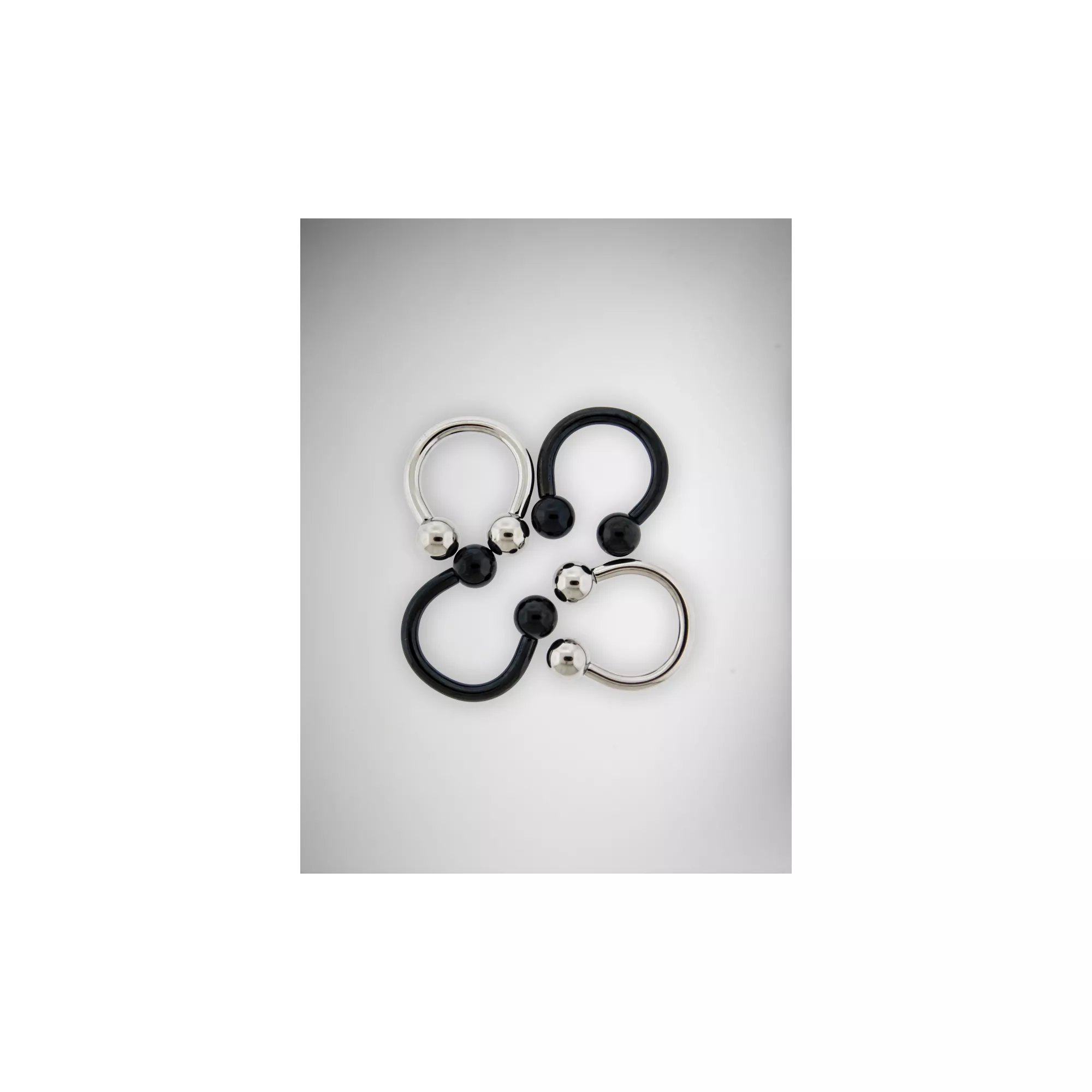 Multi-Pack Black and Silver Horseshoe Rings 2 Pair - 14 Gauge at Spencer's