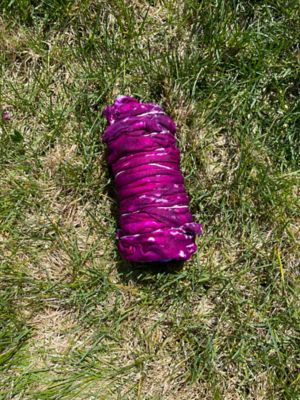 Applying dye to a shibori tie dye t shirt with rubber bands